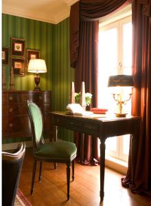 
a desk with a chair and a lamp in front of it at Brugsche Suites - Luxury Guesthouse in Bruges
