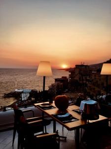a table with a view of the ocean at sunset at The Bay Apartments in Sarandë +86 photos