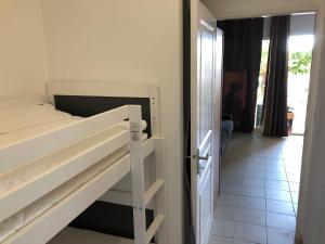 a bedroom with a bunk bed and a hallway at Porticcio centre plage à pieds, studio-cabine 4 Pers max, promo 7 nuits in Porticcio