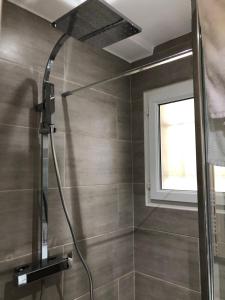 a shower with a shower head in a bathroom at Porticcio centre plage à pieds, studio-cabine 4 Pers max, promo 7 nuits in Porticcio +38 photos