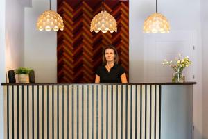 a woman standing behind a counter in a room at Rudy Lis Szczyrk in Szczyrk