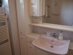 a bathroom with a white sink and a mirror at B&B Villa Filotea & Apartment in Desenzano del Garda