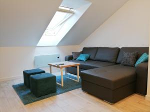 a living room with a couch and a table at De Luxe Blue Mare in Łukęcin