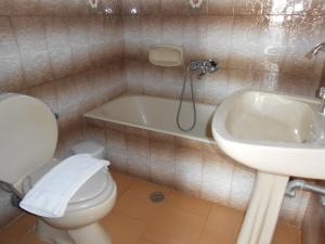 a bathroom with a toilet and a sink and a tub at Villas Michalis in Chorafakia