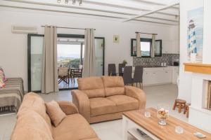 a living room with a couch and a chair at Villa Venetia Corfu in Agnítsini