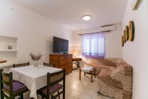 a living room with a couch and a table at Apartments Amalia in Podgora