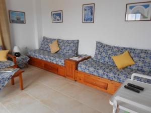 a living room with two couches in a room at Villas Michalis in Chorafakia