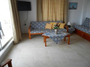a living room with a couch and a table at Villas Michalis in Chorafakia