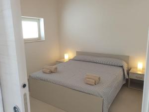 Postel nebo postele na pokoji v ubytování A(m)mare - casa vacanze