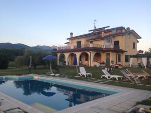 a house with a swimming pool in front of it at Villa Naclerio in Sarzana