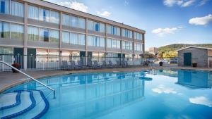 a swimming pool in front of a building at Best Western Plus Bradford Inn in Bradford