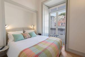 a bedroom with a large bed and a window at Unique 2 Bdr Apt River View Baixa Alfama C in Lisbon