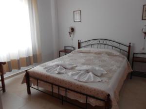 a bedroom with a bed with two towels on it at Villas Michalis in Chorafakia