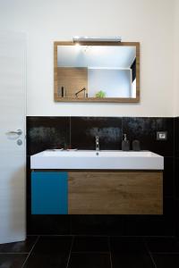 a bathroom with a sink and a mirror at Una Finestra sul Lago in Molveno +27 photos