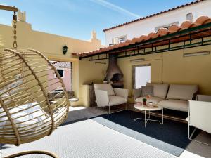 a patio with a couch and chairs and a fireplace at Lisbon Alfama Terrace in Lisbon