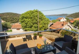 a balcony of a house with a view of the ocean at Apartments Ivica - 100m from the sea in Drvenik Veli