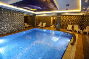 uma piscina com uma fonte num quarto de hotel em Thermal Saray Hotel & Spa Yalova em Gokcedere