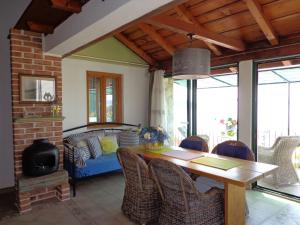 a dining room with a table and chairs and a couch at Apartments Peric in Igrane