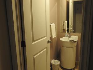 a bathroom with a white toilet and a sink at Jubilee Ocean Front in Topsail