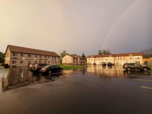 a group of cars parked in a parking lot with a rainbow at Stay Vacation Homes Niagara Falls in Niagara Falls