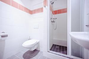 a bathroom with a toilet and a sink and a shower at Domov mládeže - Ubytování Sokolov in Sokolov