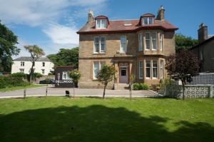 a large brick house on a street at Dellwood Hotel in Campbeltown