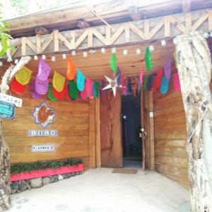 a wooden house with colorful decorations on it at Lola Atlachinolli in Sayulita