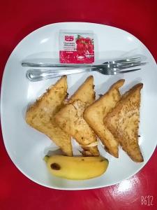 a plate with a banana and french fries at Memory Hotel in Vientiane
