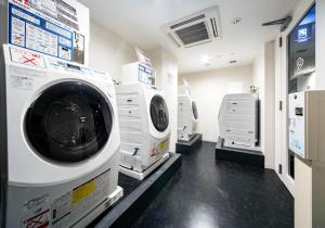 a laundry room with a washer and dryer at Daiwa Roynet Hotel Ginza PREMIER in Tokyo