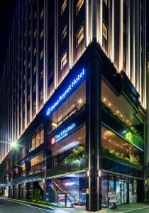 a building with a sign on the front of it at Daiwa Roynet Hotel Ginza PREMIER in Tokyo