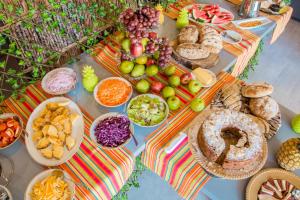 a table topped with lots of different types of food at Casa Avelina Boutique Hostel in Santa Marta