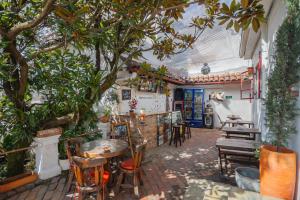 a restaurant with a table and chairs and trees at Botanico Hostel in Bogotá