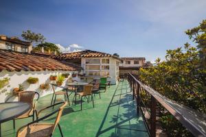 a balcony with tables and chairs on a building at Botanico Hostel in Bogotá