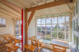 a classroom with tables and a large window at Botanico Hostel in Bogotá
