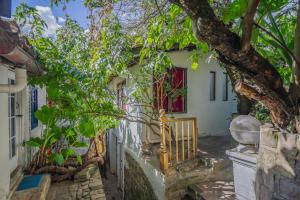 a house with a tree in front of it at Botanico Hostel in Bogotá
