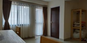 A bed or beds in a room at Sayami Home