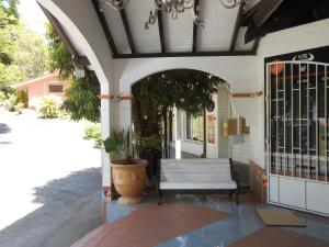 an entrance to a building with a white bench at Entre Mer et Verdure in Sainte-Anne