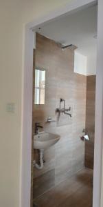 a bathroom with a sink and a shower at Sayami Home in Pātan