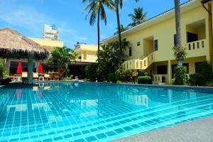 a swimming pool in front of a hotel at Austrian Garden Hotel & Restaurant Patong in Patong Beach