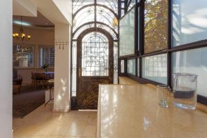 a glass vase sitting on a table in front of a door at Colony Suites - Emek Refaim in Jerusalem