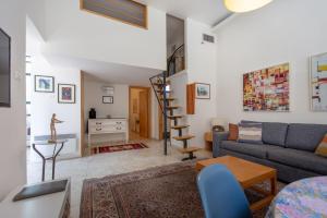 a living room with a couch and a table at Colony Suites - Emek Refaim in Jerusalem