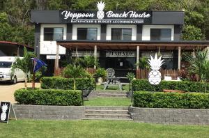 a restaurant with a pineapple sign in front of it at Yeppoon Beachhouse in Yeppoon