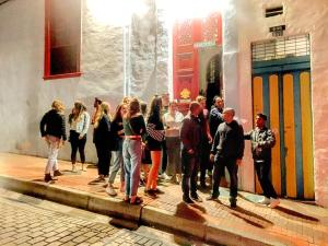 a group of people standing outside of a building at Botanico Hostel in Bogotá