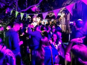 a group of people dancing at a party at Botanico Hostel in Bogotá