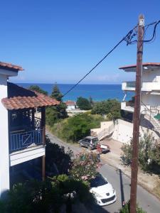 a view of the ocean from the balcony of a building at Anemoxadi Apartments in Siviri