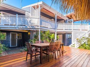 a wooden deck with a table and chairs on a house at Kenlee in Yamba
