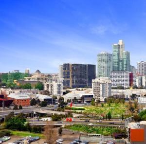 a city skyline with tall buildings and a freeway at ReadySet Apartments at City Tower in Melbourne