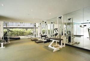 a gym with treadmills and machines in a building at ReadySet Apartments at City Tower in Melbourne