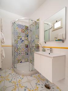 a bathroom with a shower with a sink and a mirror at Hotel Il Girasole in Anacapri