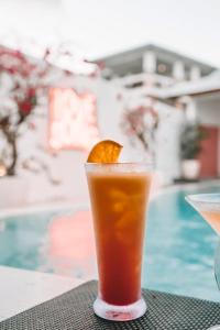 a drink with an orange slice on a table at Love Song Boutique Hotel in Canggu